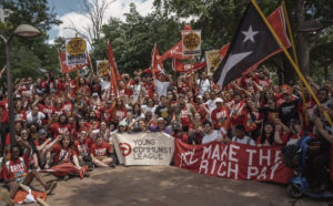 A large crowd of YCL members pose with banners